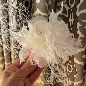 Floral fascinator with birdcage and comb.